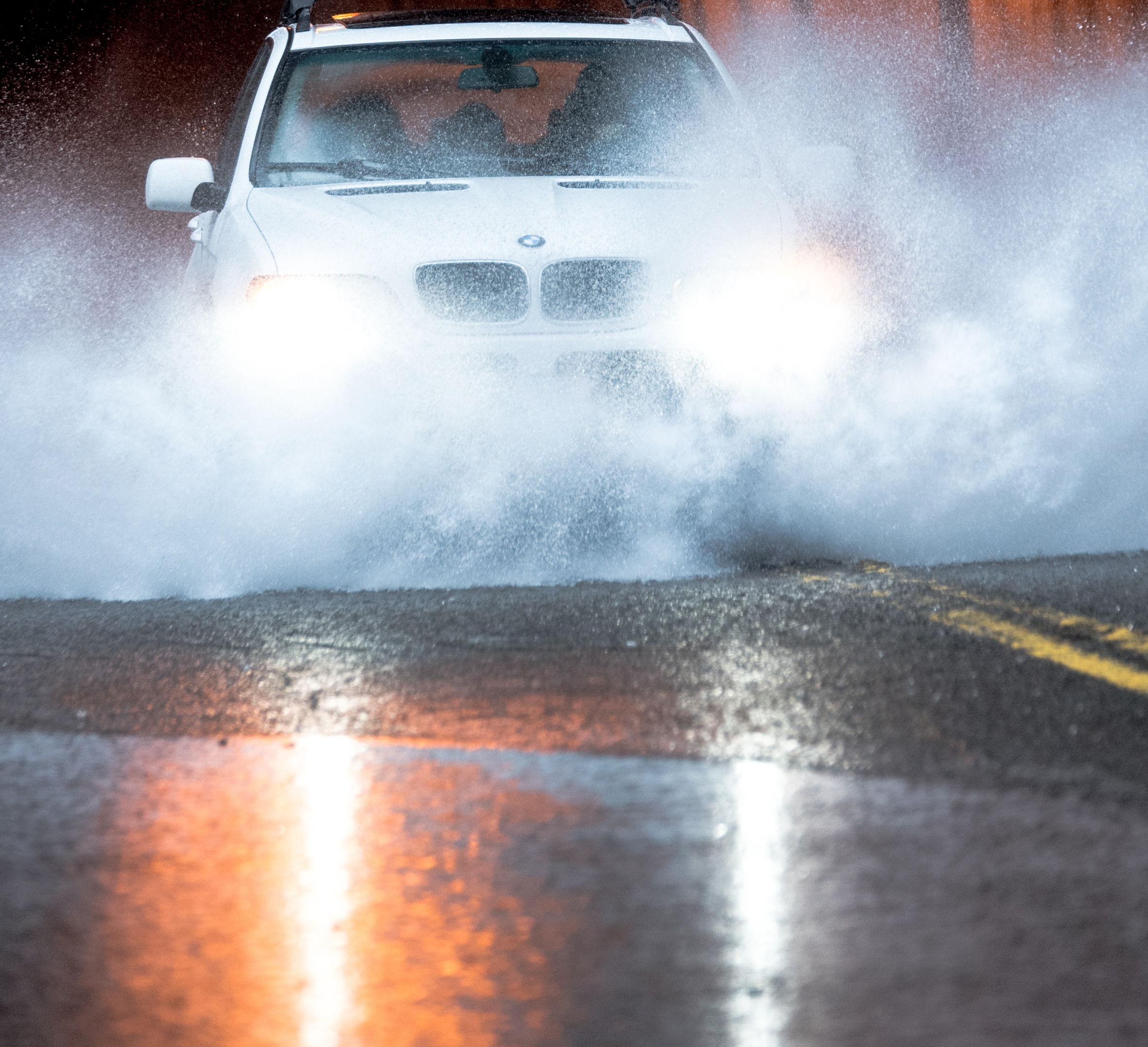Car driving through flooded street