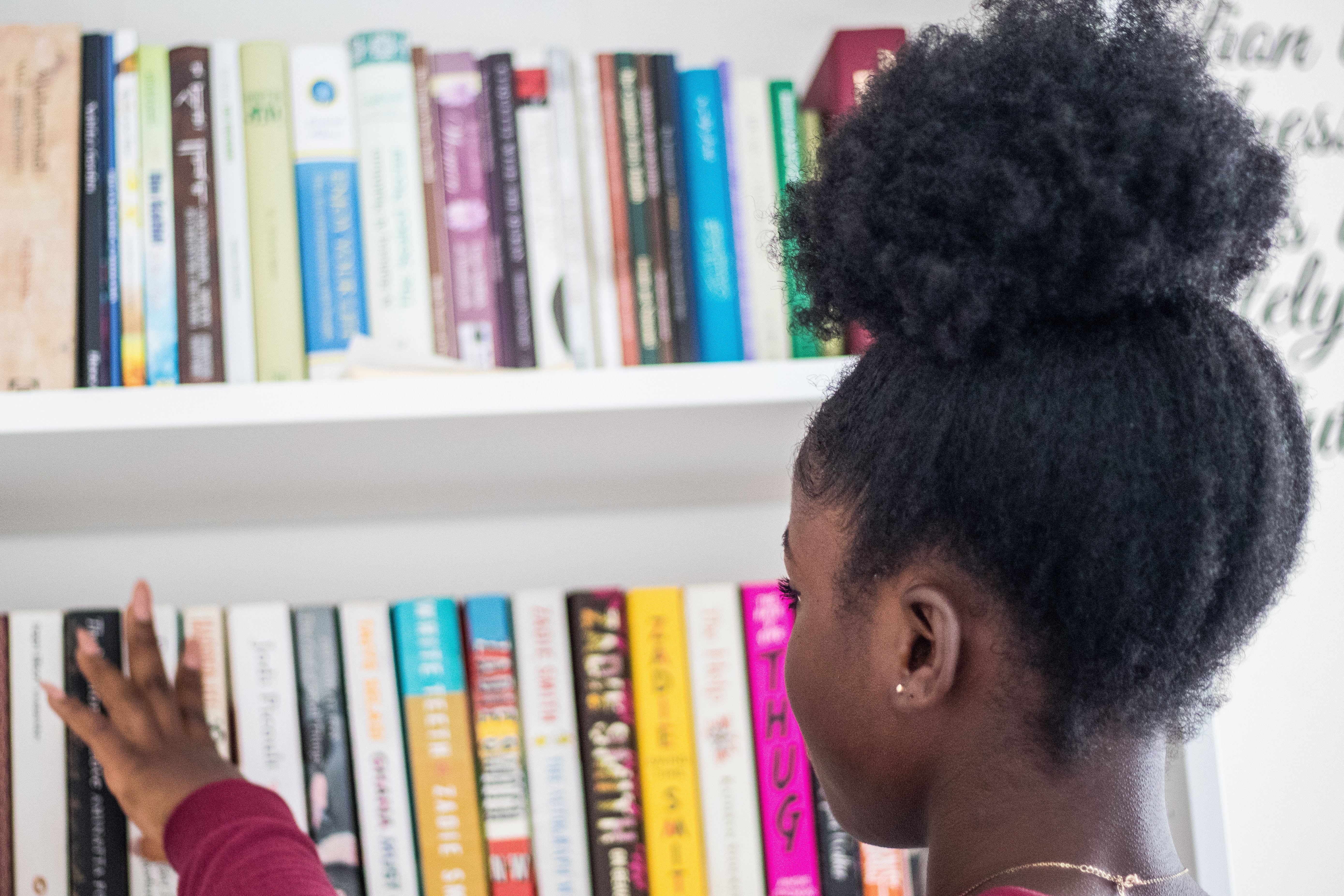 Black girl looking at books