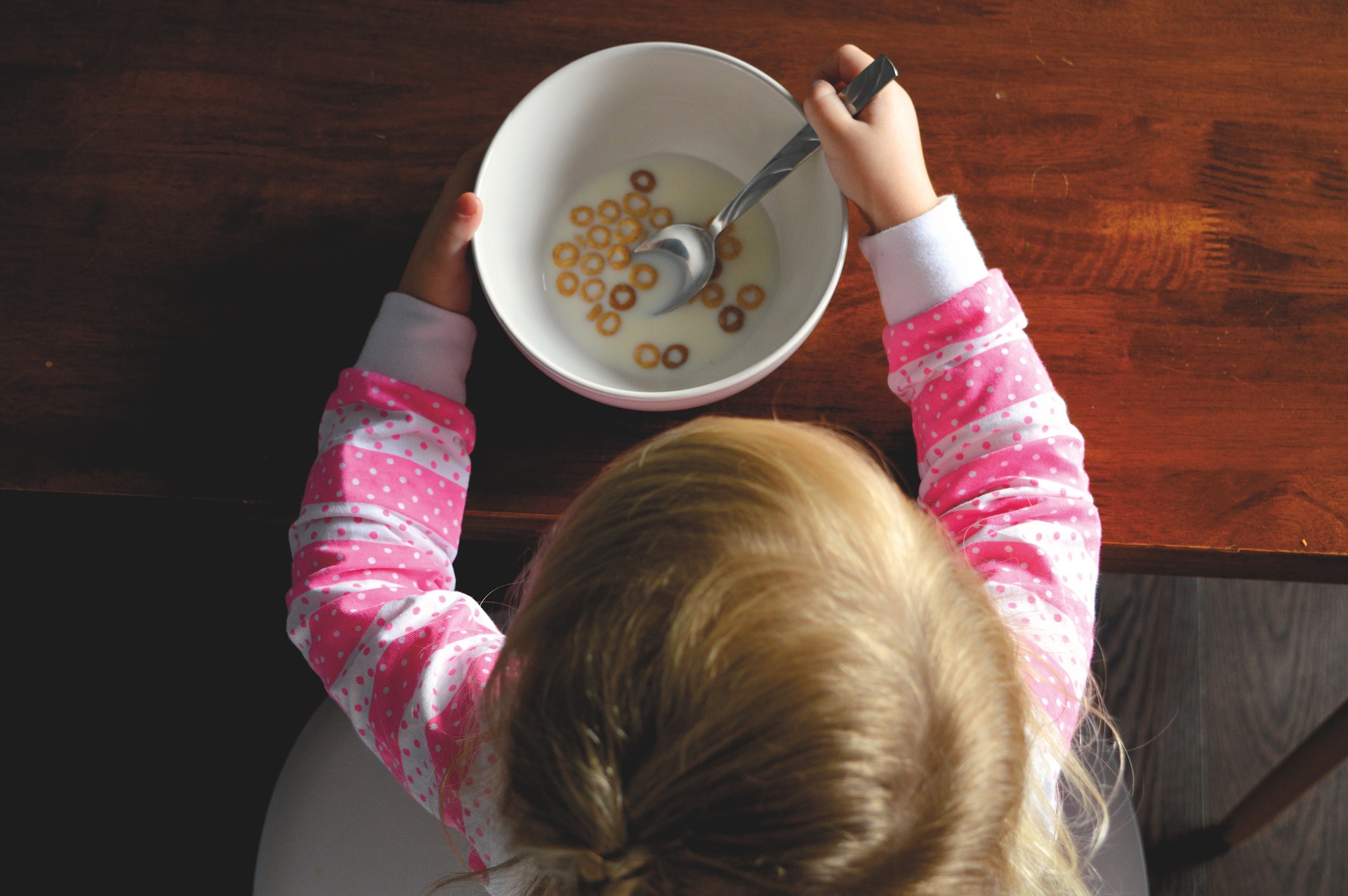 Girl eating cereal - summer feeding