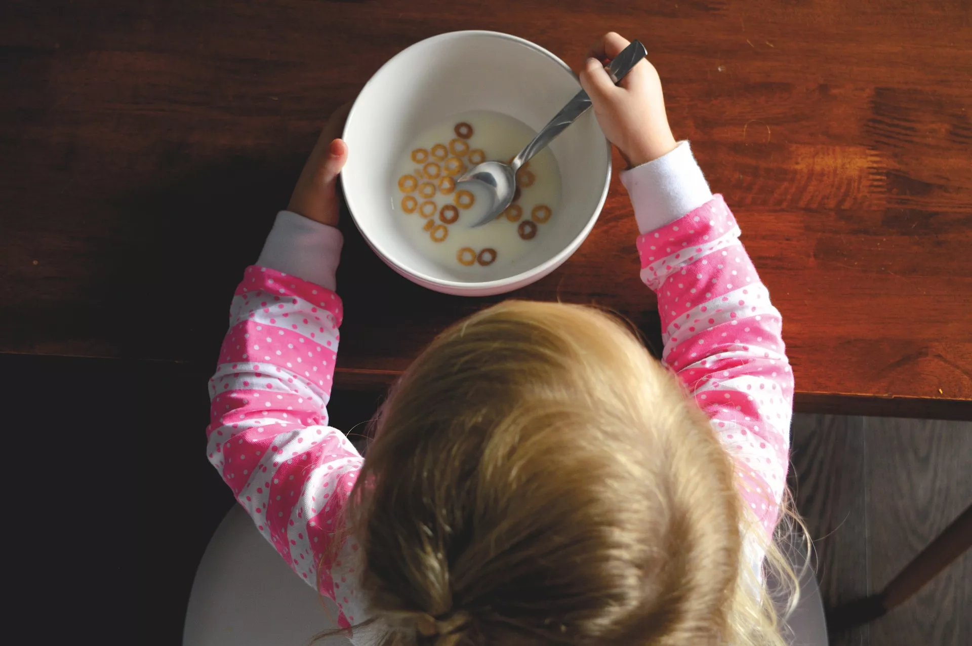 Girl eating cereal - summer feeding