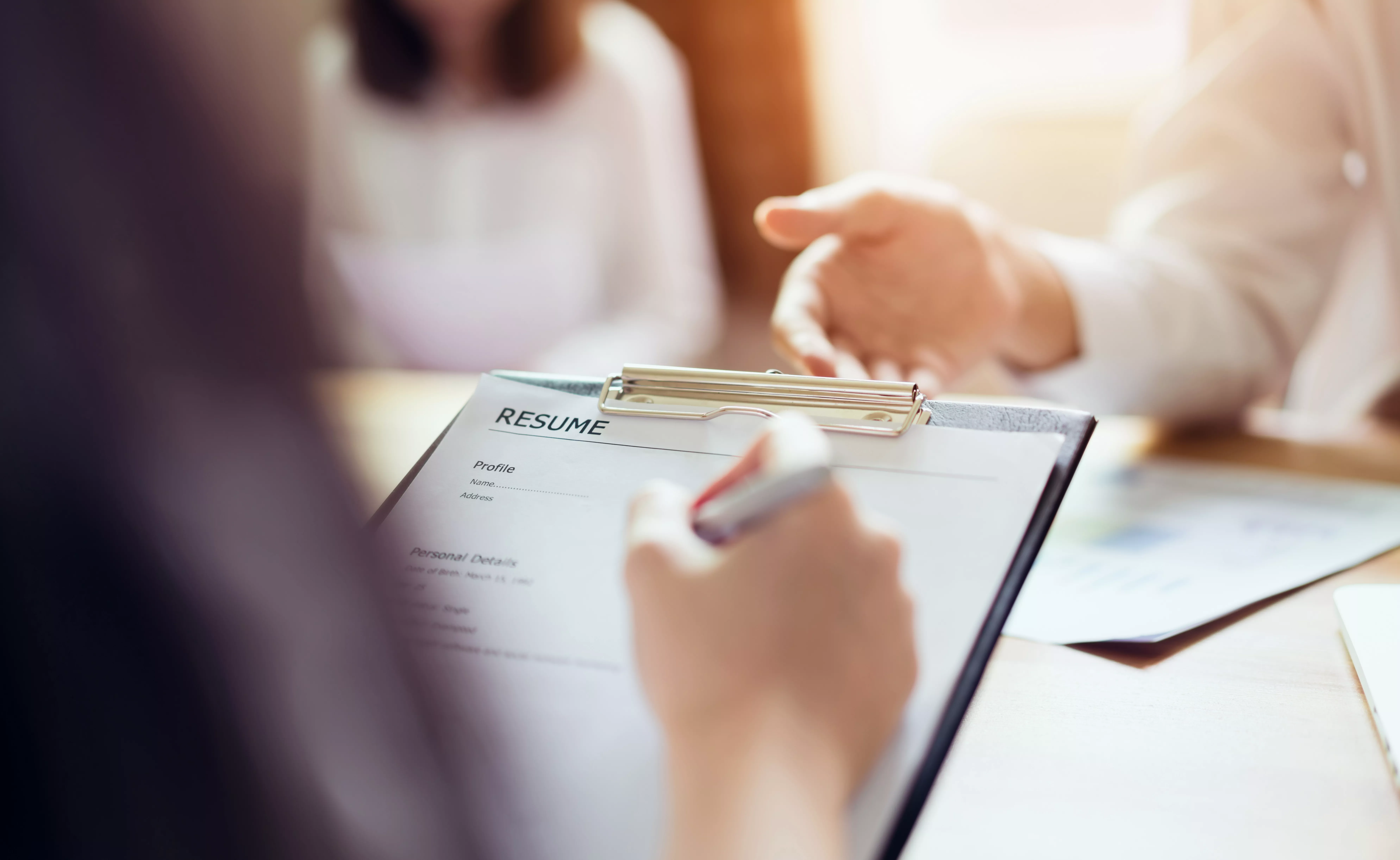 Person holding resume in job interview. 